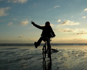 Karen on her bike, on low tide, sunset beach in Shoreham - the birth of an idea