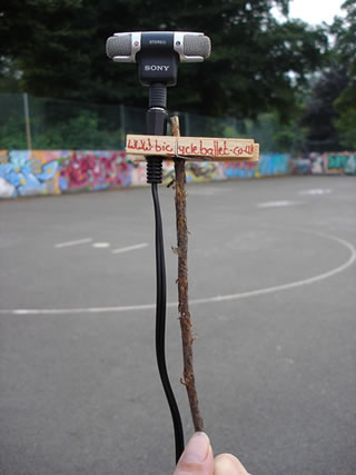 small microphone attached to a stick by a peg with Bicycle Ballet written on it