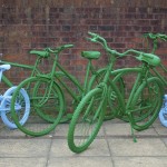 painted bikes leaning against wall