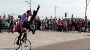 boy doing a scissor kick, jump over the handlebars of moving bike