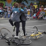 Two participants dance tango between two bikes lying on the ground
