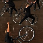 performers with their bikes strike a pose