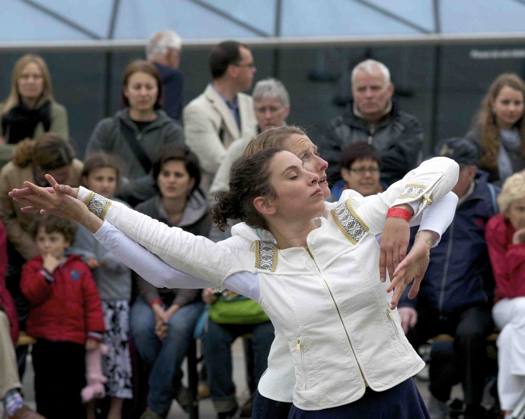 the character Sorry holds Happiness' arms from behind, manipulating her like a puppet